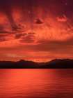 USA, Washington State, Seabeck. Vivid sunset over Hood Canal and Olympic Mountains. Art Print